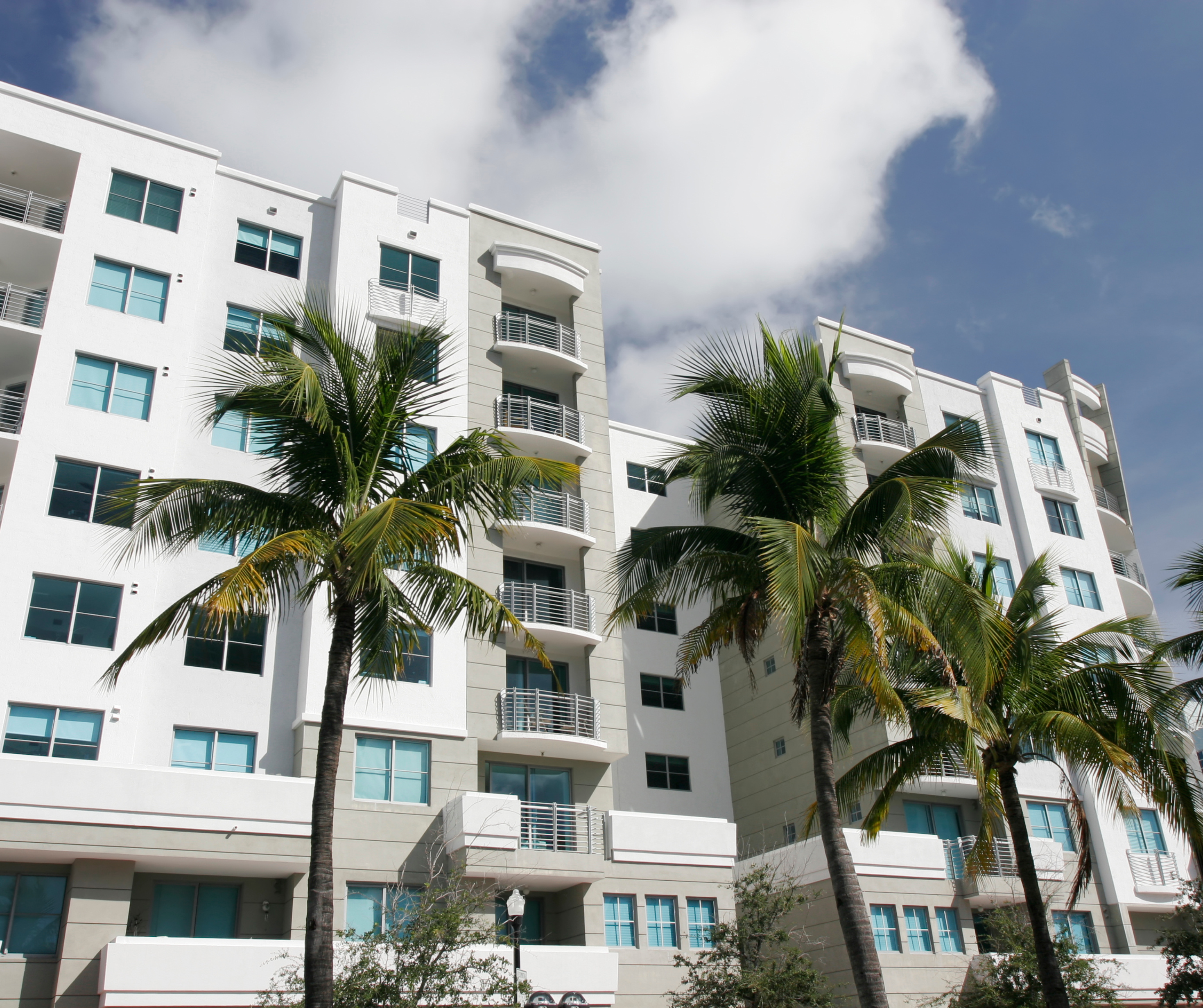 White condo houses with palm trees