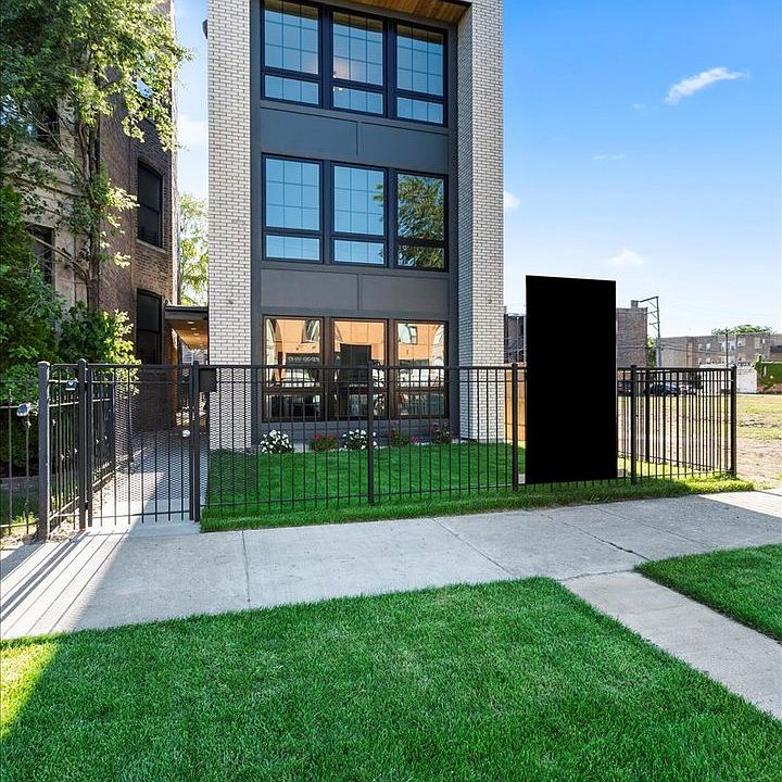 Condo apartments with walkway and small courtyard in a sunny day