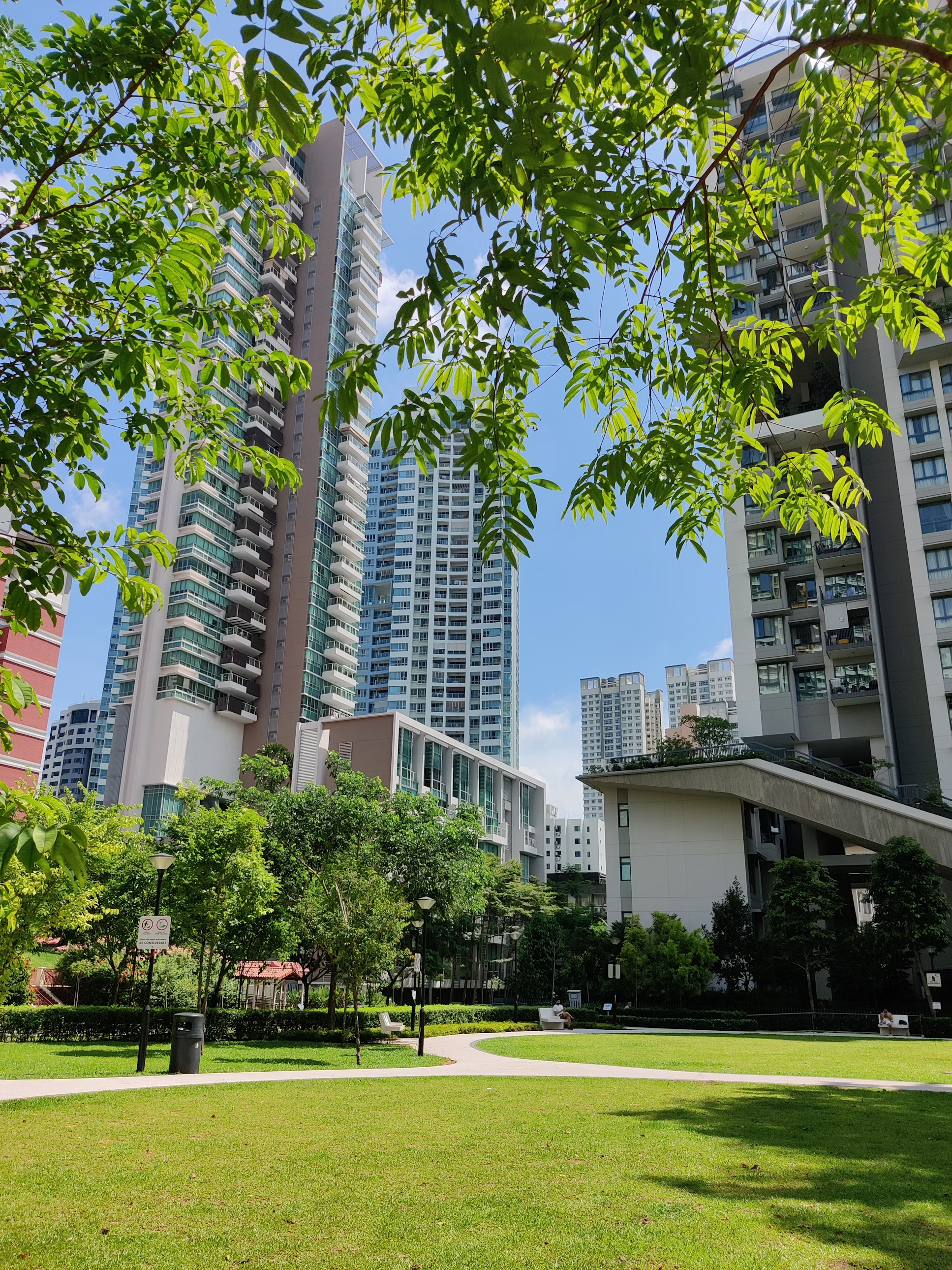 Tall Apartment Building with a beautiful pedestrian strip in the garden