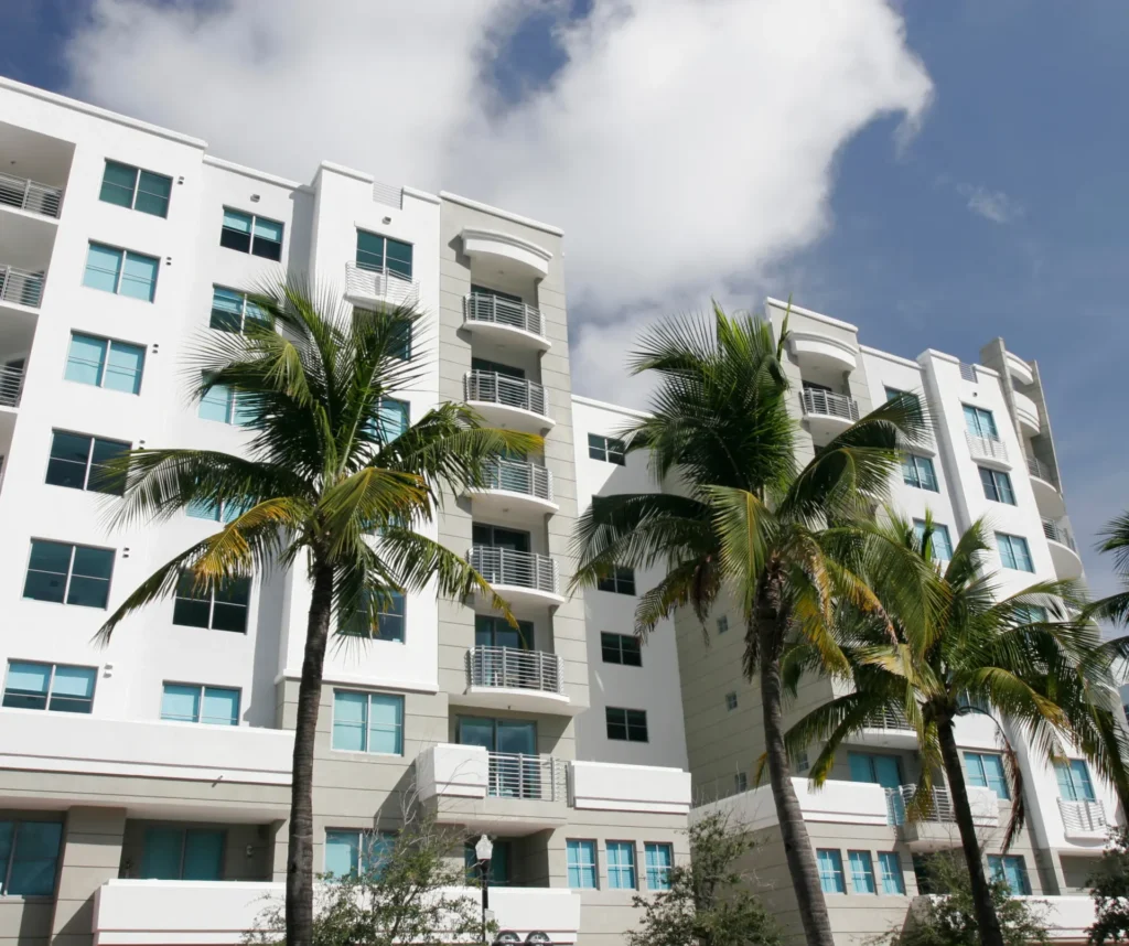 palm trees in front of apartment building